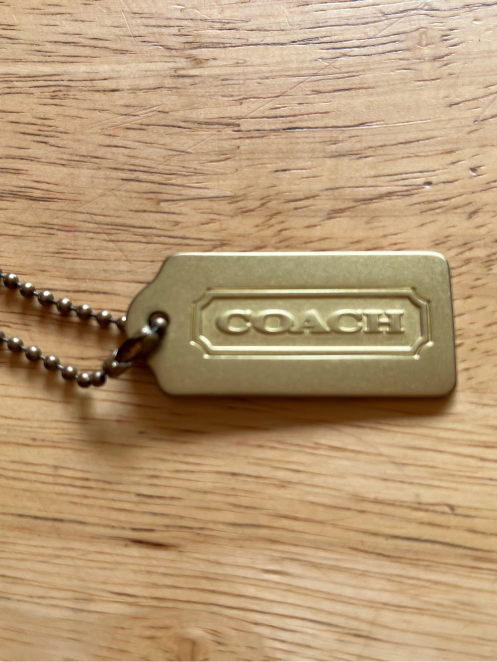 COACH gold brass metal hang tag